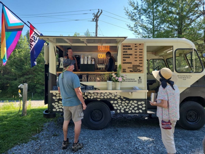 Customers stand in front of the coffee truck deciding on their orders
